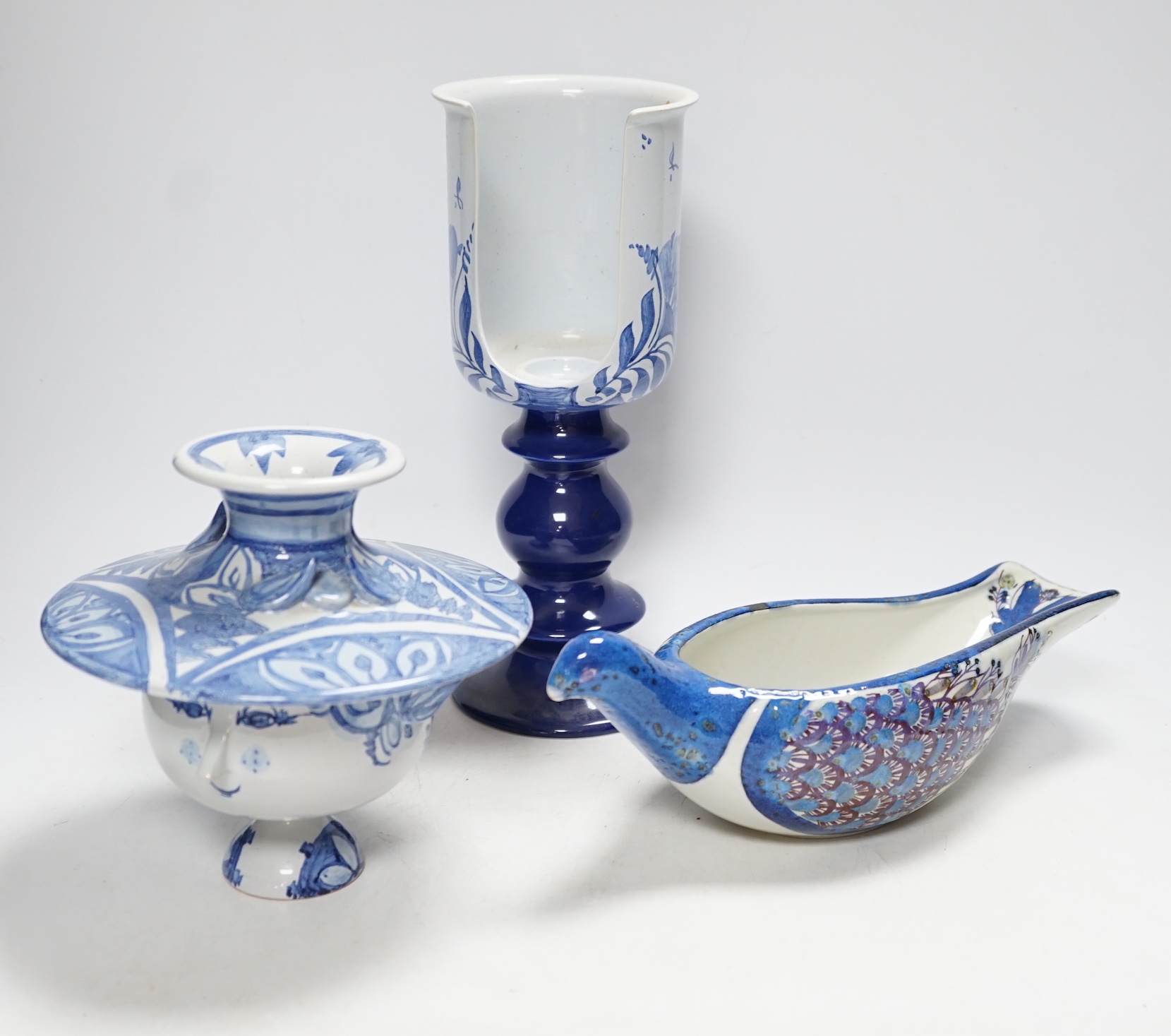 Two Danish ceramic items designed by Bjorn Wiinblad; a lidded pedestal cup in the form of a head with large hat and a candlestick, 26cm high, together with a bird sauce boat signed BJ on base (Berte Jesson)